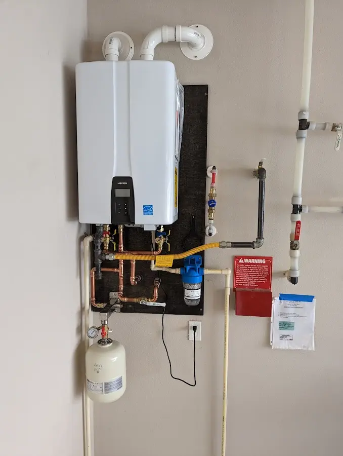 Professional plumber installing copper piping in a Live Oak home